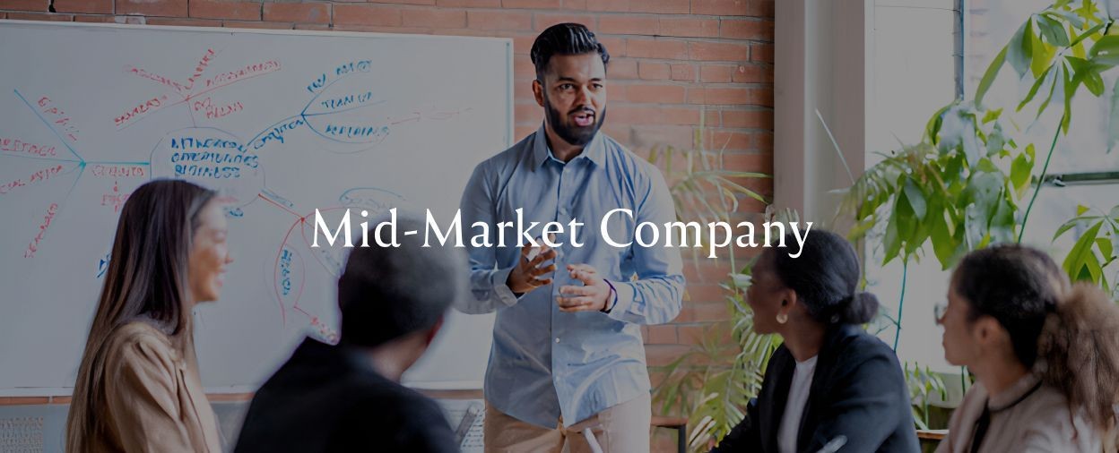 A young professional man leads a small business meeting in modern office conference room space